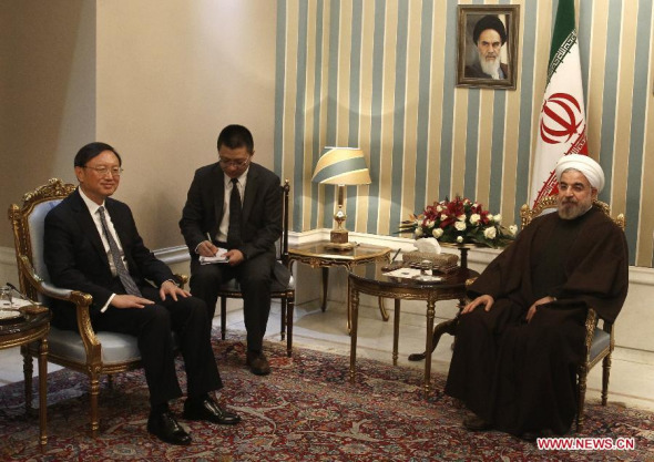 Iranian President Hassan Rouhani (R) meets with visiting Chinese State Councilor Yang Jiechi (L) in Tehran, capital of Iran, on Dec. 8, 2013. (Xinhua/Ahmad Halabisaz)