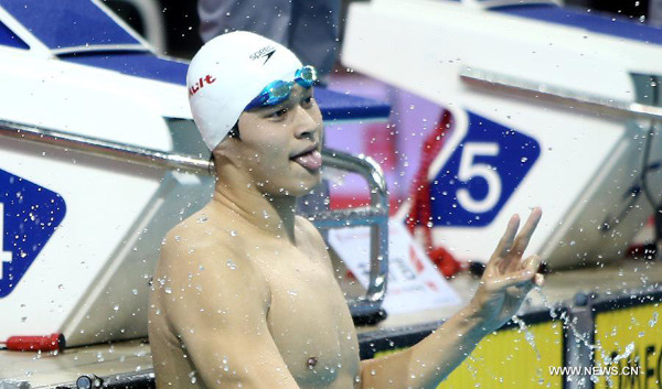 Sun Yang of Zhejiang celebrates after winning the men's 200m freestyle final of the 12th Chinese National Games in Shenyang, northeast China's Liaoning Province, Sept. 6, 2013. Sun Yang won the gold and set a new Asian record with a time of 1 minute 44.47 seconds. (Xinhua File Photo/Liao Yujie)