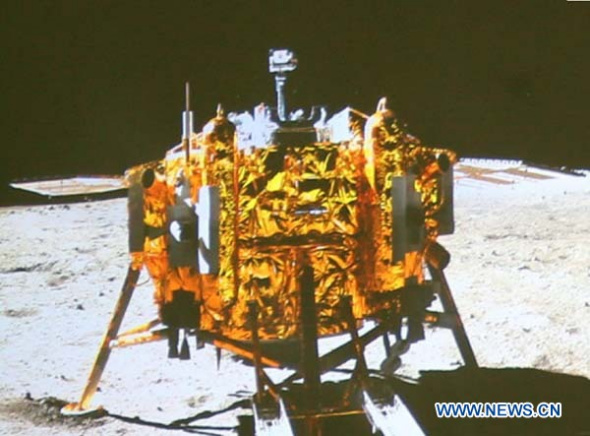 Screen shows the photo of the Chang'e-3 moon lander taken by the camera on the Yutu moon rover during the mutual-photograph process, at the Beijing Aerospace Control Center in Beijing, capital of China, Dec. 15, 2013. The moon rover and the moon lander took photos of each other Sunday night, marking the complete success of the Chang'e-3 lunar probe mission. (Xinhua/Wang Jianmin)