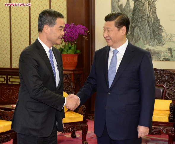 Chinese President Xi Jinping(R) meets with Leung Chun-ying, chief executive of Hong Kong Special Administrative Region (HKSAR), in Beijing, capital of China, Dec. 18, 2013. Leung is in Beijing to brief officials on Hong Kong's latest economic, social and political developments. (Xinhua/Ma Zhancheng)