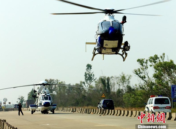 Helicopters and police cars are seen during an anti-drug raid on Sunday in south China's Guangdong province. Police seized three tonnes of crystal meth in the raid. (Photo: China News Service)
