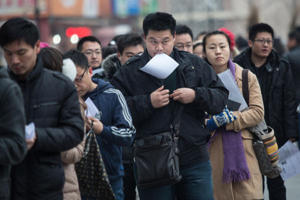 Candidates for the national graduate entrance examination line up for a test at the University of International Business and Economics in Beijing on Saturday. MAO YANZHENG / CHINA DAILY