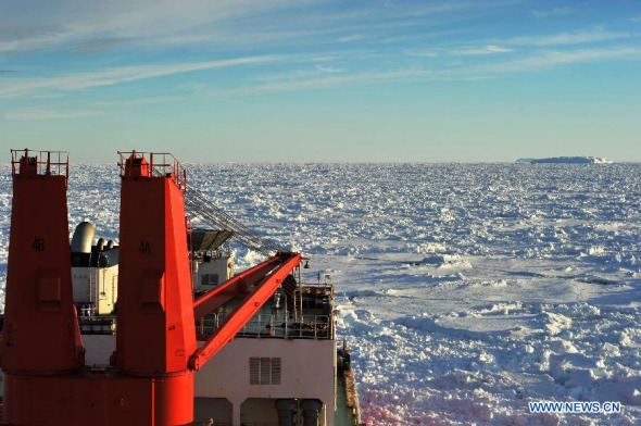 The Chinese icebreaker <i>Xuelong</i>, or Snow Dragon, anchors in a sea-ice field off Antarctica, Jan. 3, 2014. Xuelong is blocked by thick ice after successfully transferred passengers aboard stranded Russian science vessel MV Akademik Shokalskiy Thursday. (Xinhua/Zhang Jiansong) 