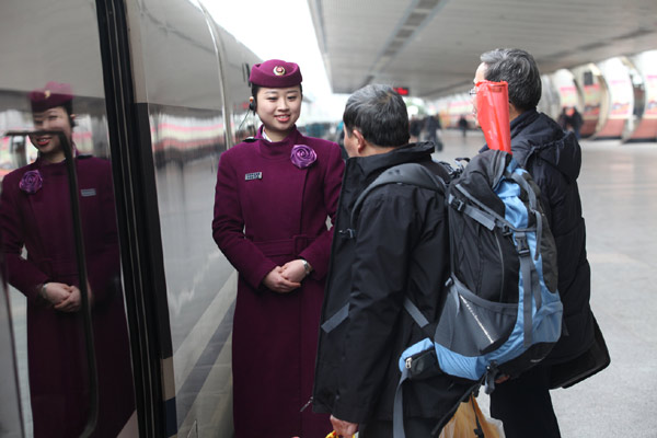 Travelers board a high-speed train in Guilin in the Guangxi Zhuang autonomous region. Guangxi became the country's first ethnic autonomous region to be integrated into the national high-speed railway network. Chen Fuping / for China Daily 