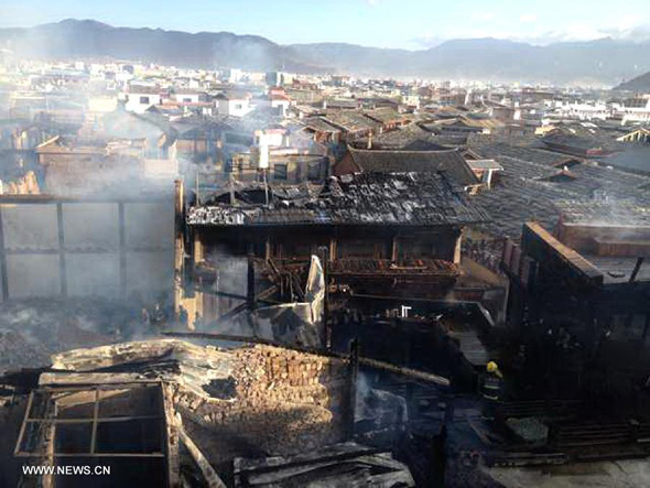 The cellphone photo taken on Jan 11, 2014 shows Dukezong Ancient Town after fire, in Shangri-la County, southwest China's Yunnan Province. A fire broke out early Saturday in the Dukezong Ancient Town. The blaze was basically under control and there were no immediate reports of casualties. (Xinhua)