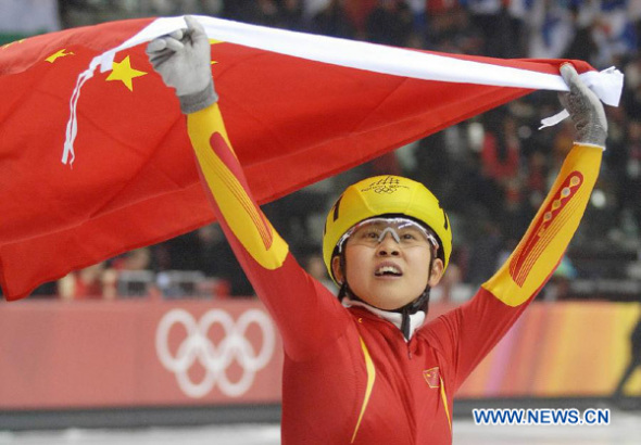 In this Feb. 15, 2006 file photo, four-time Olympic short track speedskating champion Wang Meng celebrates after the women's 500m final in the Winter Olympic Games in Turin, Italy. Wang Meng probably will miss the Sochi Winter Games after she sustained a serious ankle injury on Thursday. Wang was diagnosed with tibia abd fibula fractures in her right ankle in the Shanghai Huashan Hospital and doctors said she has to receive an internal fixation surgery. (Xinhua/Li Gang)