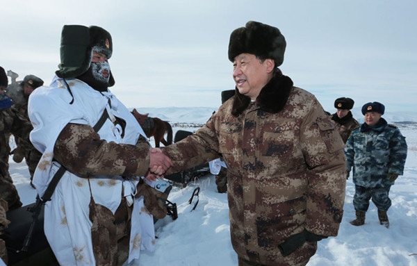 President Xi Jinping offers Lunar New Year greetings to a guard at an army base at Mount Sanjiao in Hinggan League, the Inner Mongolia autonomous region, on Sunday, where temperatures hovered around -30 C. Photo by Zhou Chaorong / for China Daily 