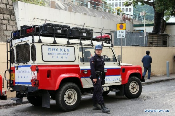 A bomb disposal vehicle parks at the venue where a suspected World War II bomb was found by construction workers who were digging underground structure for a hotel on Queen's Road East in Hong Kong island, south China's Hong Kong, Feb 6, 2014. (Xinhua/Li Peng)