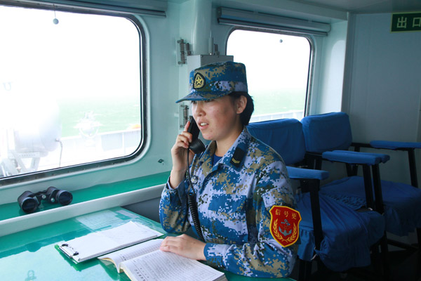 Alimra Jumadel (first from left), a Kazak woman who serves on the PLA navys amphibian landing craft Changbaishan, is on duty on the navigation bridge. Gan Jun / for China Daily