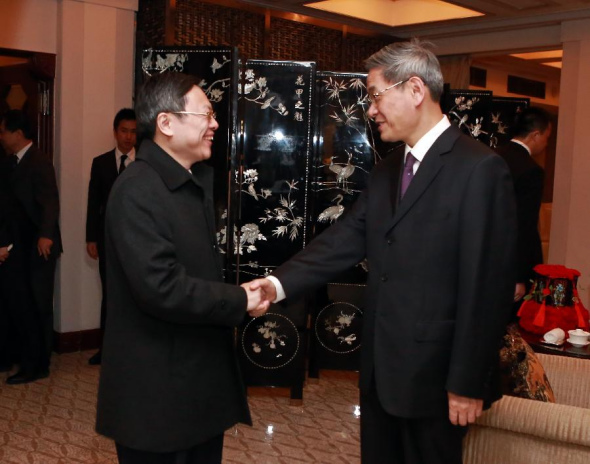 Zhang Zhijun (R), head of the State Council Taiwan Affairs Office (SCTAO), shakes hands with Wang Yu-chi, Taiwan's mainland affairs chief, during their chat at a cafe in the Peace Hotel of Shanghai, east China, Feb 13, 2014. (Xinhua)