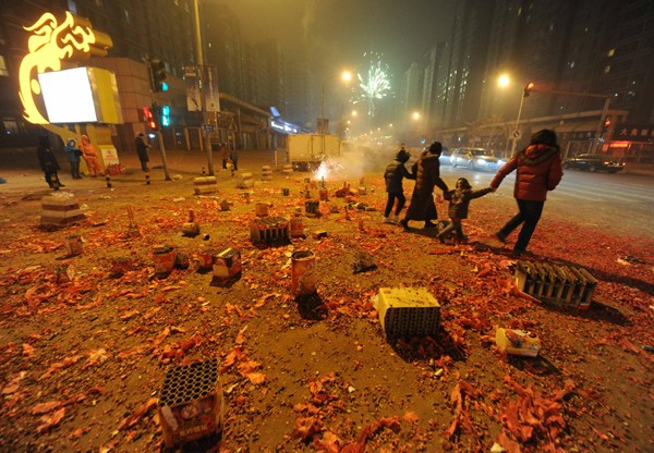 People leave after playing fireworks in Beijing on Friday. [Photo/Xinhua]