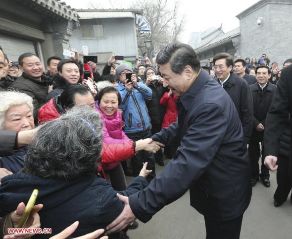 Chinese President Xi Jinping (C), also general secretary of the Communist Party of China (CPC) Central Committee and chairman of the Central Military Commission, shakes hands with residents as he visits a historical and cultural preservation area along the banks of the Yuhe River during an inspection tour in Beijing. (Xinhua/Ding Lin) 