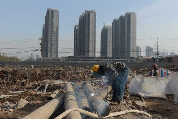 Preliminary work on new housing on the site of a former shantytown gets underway in Taiyuan, Shanxi province. The pace of urbanization in China is slowing as local government debt threatens social spending plans. [LIU JING/FOR CHINA DAILY]
