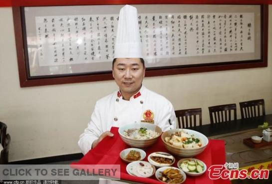 A chef at a local restaurant in Shaanxi province shows the "Xi-Lien set meal", including a Chinese burger, mutton paomo, Biangbiang noodle, and four cold dishes.