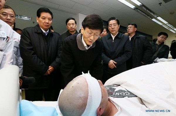 Meng Jianzhu, head of the Central Commission for Political and Legal Affairs of the Communist Party of China, visits an injured civilian at No. 1 People's Hospital in Kunming, capital of southwest China's Yunnan Province, March 2, 2014. At least 29 innocent people were killed and more than 130 others injured during a terrorist attack at the Kunming Railway Station Saturday night. (Xinhua/Hao Fan)