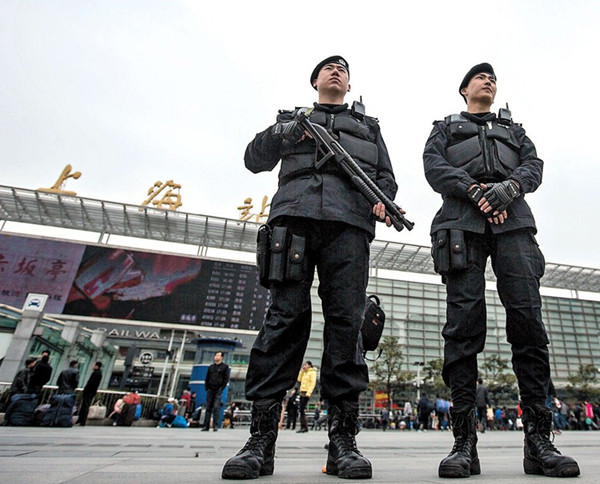 The scene at the main railway station in Shanghai Sunday as two armed police officers stand guard in the station square. (Xu Xiaolin) 