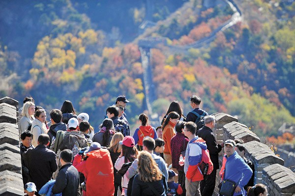 Visitors take in the sights at Mutianyu, a famous section of the Great Wall. A special area of the wall has been established for graffiti to better protect the heritage site after media reported that many foreign tourists had carved words on the old buildings. Photo by Chen Yehua / Xinhua 