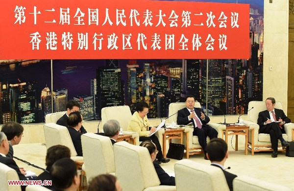 Zhang Dejiang (2nd R, rear), chairman of the Standing Committee of China's National People's Congress (NPC) and a member of the Standing Committee of the Political Bureau of the Communist Party of China (CPC) Central Committee, joins a discussion with deputies from south China's Hong Kong Special Administrative Region during the second session of the 12th NPC, in Beijing, capital of China, March 6, 2014. (Xinhua/Liu Jiansheng)  