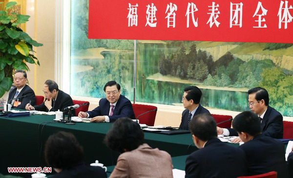 Zhang Dejiang (3rd L, rear), chairman of the Standing Committee of China's National People's Congress (NPC) and a member of the Standing Committee of the Political Bureau of the Communist Party of China (CPC) Central Committee, joins a discussion with deputies to the 12th NPC from southeast China's Fujian Province during the second session of the 12th NPC, in Beijing, capital of China, March 7, 2014. (Xinhua/Yao Dawei) 
