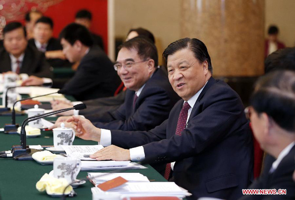 Liu Yunshan (2nd R), a member of the Standing Committee of the Political Bureau of the Communist Party of China (CPC) Central Committee and secretary of the Secretariat of the CPC Central Committee, joins a discussion with deputies to the 12th National People's Congress (NPC) from northeast China's Liaoning Province during the second session of the 12th NPC, in Beijing, capital of China, March 10, 2014. (Xinhua/Ju Peng)