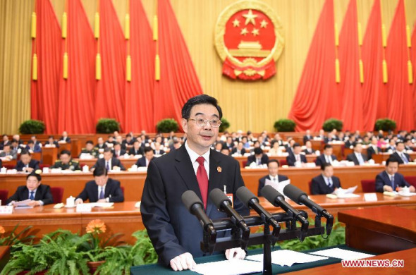 Zhou Qiang, president of China's Supreme People's Court (SPC), delivers a report on the SPC's work at the third plenary meeting of the second session of China's 12th National People's Congress (NPC) at the Great Hall of the People in Beijing, capital of China, March 10, 2014. (Xinhua/Li Xueren)