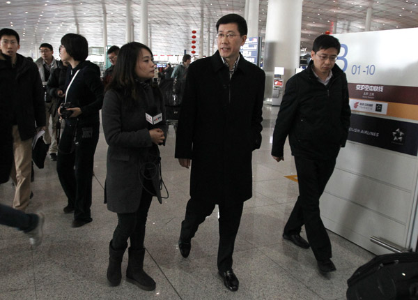 Guo Shaochun (center), head of China's joint working group for handling the Malaysia Airlines incident, is interviewed at Beijing Capital International Airport on Monday before his departure for Malaysia. Search and rescue remains the top priority at the moment, Guo said. Zhu Xingxin / China Daily 