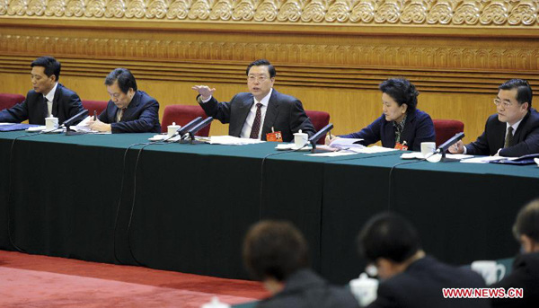 Zhang Dejiang (C), chairman of the Standing Committee of China's National People's Congress (NPC) and a member of the Standing Committee of the Political Bureau of the Communist Party of China (CPC) Central Committee, joins a discussion with deputies to the 12th NPC from north China's Hebei Province during the second session of the 12th NPC, in Beijing, capital of China, March 11, 2014. (Xinhua/Zhang Duo)