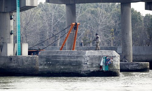 Workers repair one of the damaged supports of the Xietang Grand Bridge Monday. Photo: Yang Hui/GT