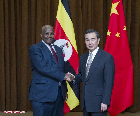 Chinese Foreign Minister Wang Yi (R) holds talks with his Ugandan counterpart Sam Kutesa in Beijing, capital of China, March. 18, 2014. (Xinhua/Wang Ye)