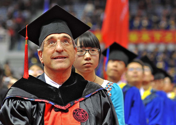 Peter Salovey, president of Yale University, attends commencement exercises for postgraduates at Shanghai Jiao Tong University on Wednesday. He was conferred with an honorary doctorate. Chen Zheng / for China Daily