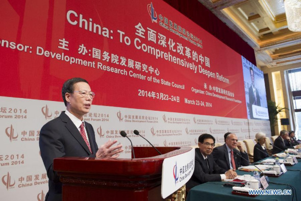 Chinese Vice Premier Zhang Gaoli (L) delivers a speech at the opening ceremony of the China Development Forum 2014 in Beijing, capital of China, March 23, 2014. (Xinhua/Huang Jingwen)