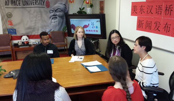 (Far side of table, from left) Malcolm Simms, a junior at Montclair State University; Linsday Bennett, program director for the Confucius Institute (CI); Weihua Niu, director for the CI; Min Zhu, Chinese director for the CI; (foreground, in red) Rebecca Smith, a sophomore at Pace University; and (foreground, in polka dots) Christine Wang, director of Overseas Students and Scholars Services for the New York Service Center for Chinese Study Fellows Inc, chat during a meeting on Monday at the Confucius Institute at Pace University in New York. 
