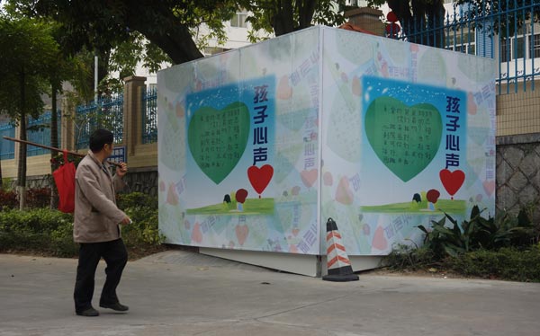 A man walks past a baby shelter outside the Guangzhou Social Welfare Home on Monday. The shelter was suspended on Sunday after receiving a total of 262 babies and children since it was put into use on Jan 28. Zou Zhongpin / China Daily