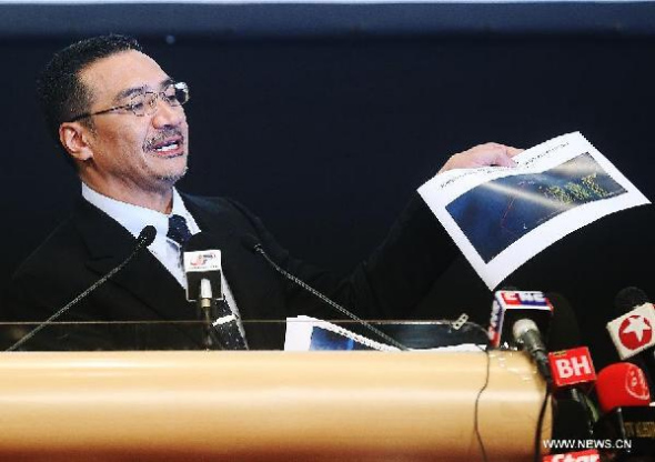 Malaysian acting Transport Minister Hishammuddin Hussein speaks during the press conference in Kuala Lumpur, Malaysia, March 26, 2014. The Malaysian government announced Wednesday that analysts studying satellite photos from France had found 122 unidentified objects floating in the southern Indian Ocean more than 2,500 km from the southwest Australia city of Perth. (Xinhua/Wang Shen)