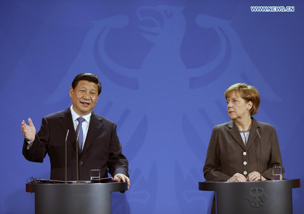 Chinese President Xi Jinping (L) and German Chancellor Angela Merkel attend a joint press conference in Berlin, Germany, March 28, 2014. [Photo: Xinhua] 