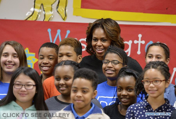 US First Lady Michelle Obama poses for photos with students at Yu Ying Public Charter School, a chinese-immersion, International Baccalaureate, elementary school, before traveling to China, in Washington D.C., US, on March 4, 2014. 