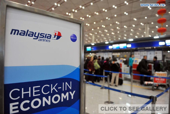 Relatives of passengers aboard the missing Malaysia Airlines flight MH370 check in before boarding a flight bound for Kuala Lumpur at Capital International Airport in Beijing, capital of China, early March 11, 2014. [Photo: Xinhua/Jiang Kehong]
