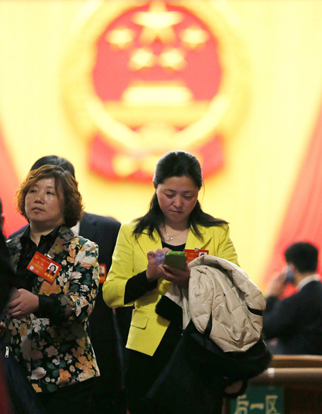NPC deputies leave the Great Hall of the People after the closing session on Thursday. Xu Jingxing / China Daily 