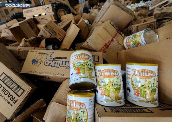 Cans of Oz Milko infant formula with tampered expiration dates are seen in an incineration company before being burnt in Beijing, capital of China, April 2, 2014. (Xinhua/Luo Xiaoguang)
