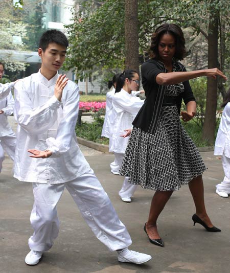 US first lady Michelle Obama joins in tai chi with students at the No 7 High School during her visit to Chengdu in late March. Wang Jing / China Daily