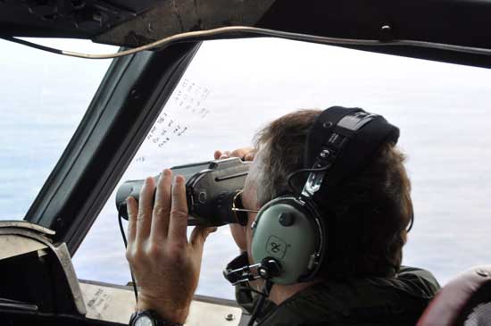 A Royal New Zealand Air Force (RNZAF) P3 Orion Rescue Flight 795 crew member  is seen during a search for debris from the missing Malaysia Airlines flight 370 at  1,500 km northwest of Perth, Australia, over the Indian Ocean, 02 April 2014.