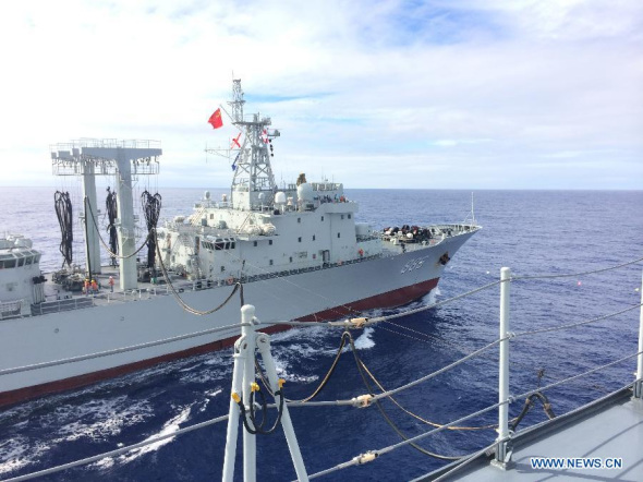 The Chinese supply ship Qiandaohu conducts a marine supply operation on the Chinese navy vessel Jinggangshan, in the southern Indian Ocean, on April 3, 2014. The four-ship Chinese naval flotilla searching for the missing Malaysia Airlines Flight MH370 reached new target area in the southern Indian Ocean Thursday, and their second round of marine supply has been accomplished. (Xinhua/Bai Ruixue) 