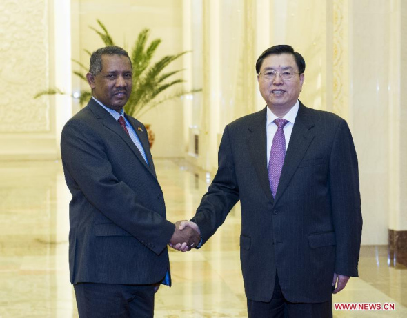 Zhang Dejiang (R), chairman of China's National People's Congress Standing Committee, shakes hands with Fatih Ezzedine al-Mansur, speaker of the National Assembly of the Republic of the Sudan, during their talks in Beijing, capital of China, April 3, 2014. (Xinhua/Wang Ye)