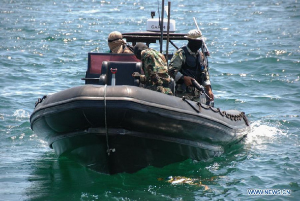Malaysian policemen patrol near the site of kidnapping in Sabah State, Malaysia on April 3, 2014. China on Thursday appealed to Malaysian police to rescue a Chinese national abducted on Wednesday night by unknown gunmen in the eastern Malaysian state of Sabah. (Xinhua)