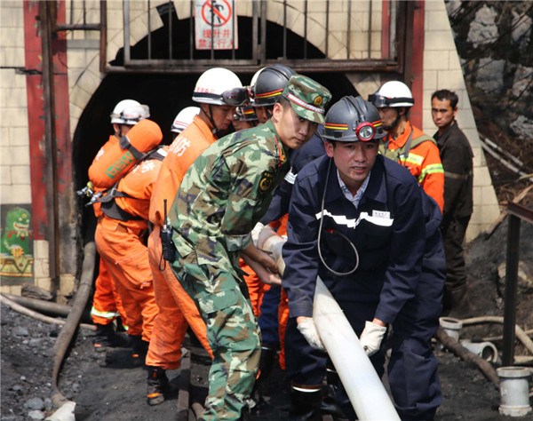 Rescuers race against time on Monday to pump water from a flooded coal mine in Qujing, Yunnan province, where 22 miners were trapped underground. [Photo/Xinhua]