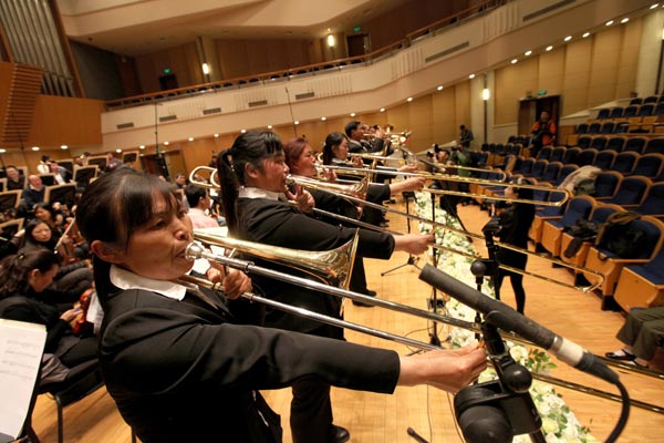 The Beidou Village Farmer Orchestra rehearses with the China National Symphony Orchestra at the Beijing Concert Hall.