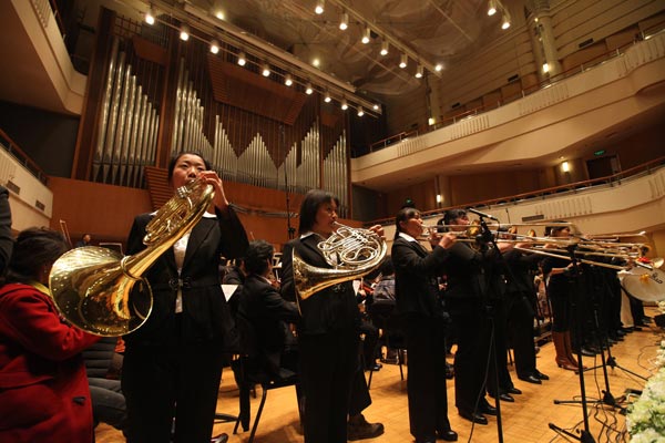 The Beidou Village Farmer Orchestra rehearses with the China National Symphony Orchestra at the Beijing Concert Hall.