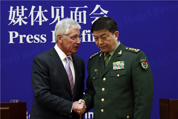 Minister of Defense Chang Wanquan chats with US Secretary of Defense Chuck Hagel during a news conference at the Ministry of National Defense headquarters in Beijing on Tuesday. FENG YONGBIN / CHINA DAILY