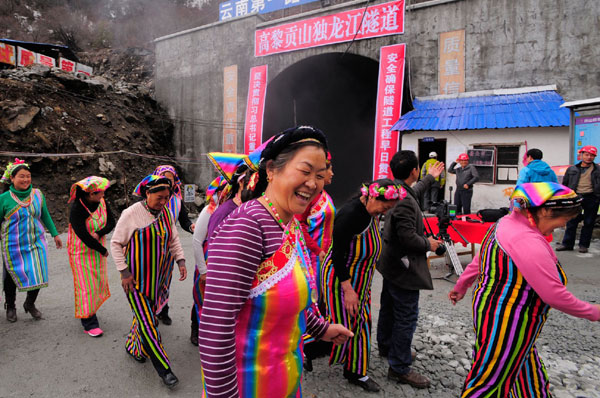 People in Dulongjiang, a township in Yunnan province, celebrate on Thursday after the breakthrough of a highway tunnel through a 3,000-meter mountain. The tunnel forms part of a highway connecting the township populated by the Derung people, China's smallest ethnic group, to the provincial highway network. The route is expected to open in June. Zhou Mingjia for China Daily