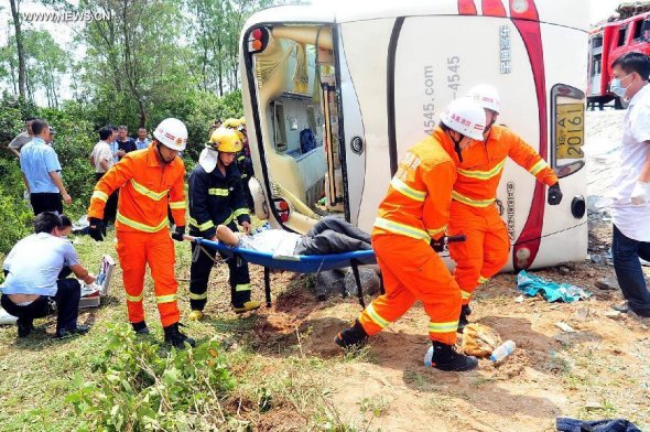 Rescuers work at the accident site after a bus for spring-outing overturned in Dongge township of Wenchang City, south China's Hainan Province, April 10, 2014. Eight pupils died and more than 10 others were injured after their bus overturned here Thursday morning. The accident happened at about 11am when the children were on a bus for a school-organized outing. (Xinhua)